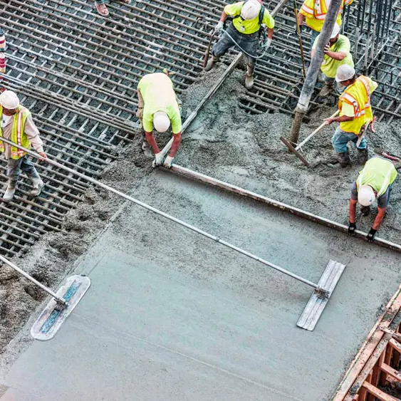 Construction workers pouring reinforced concrete foundation